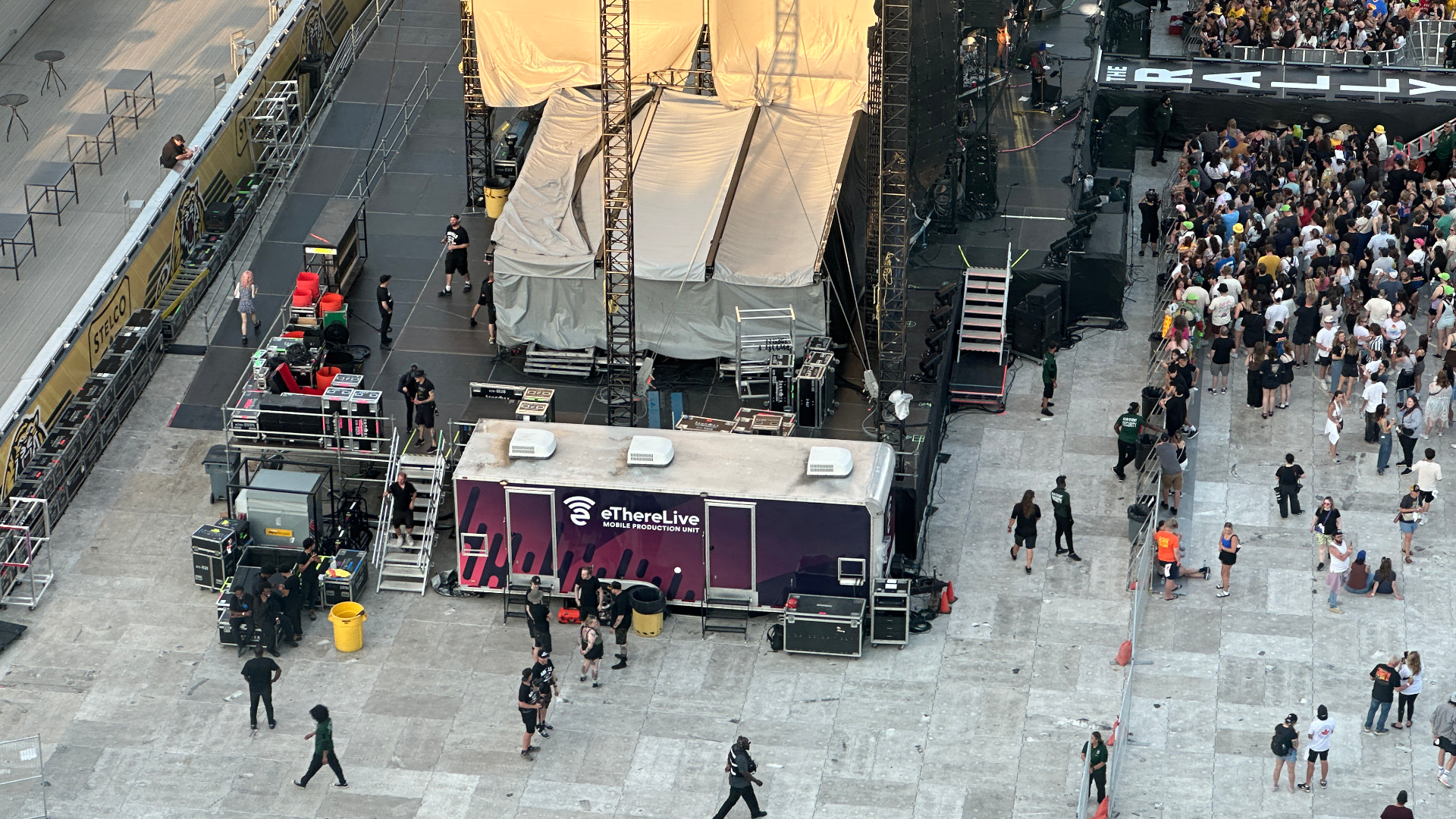 A mobile production unit seen sidestage at a large scale concert