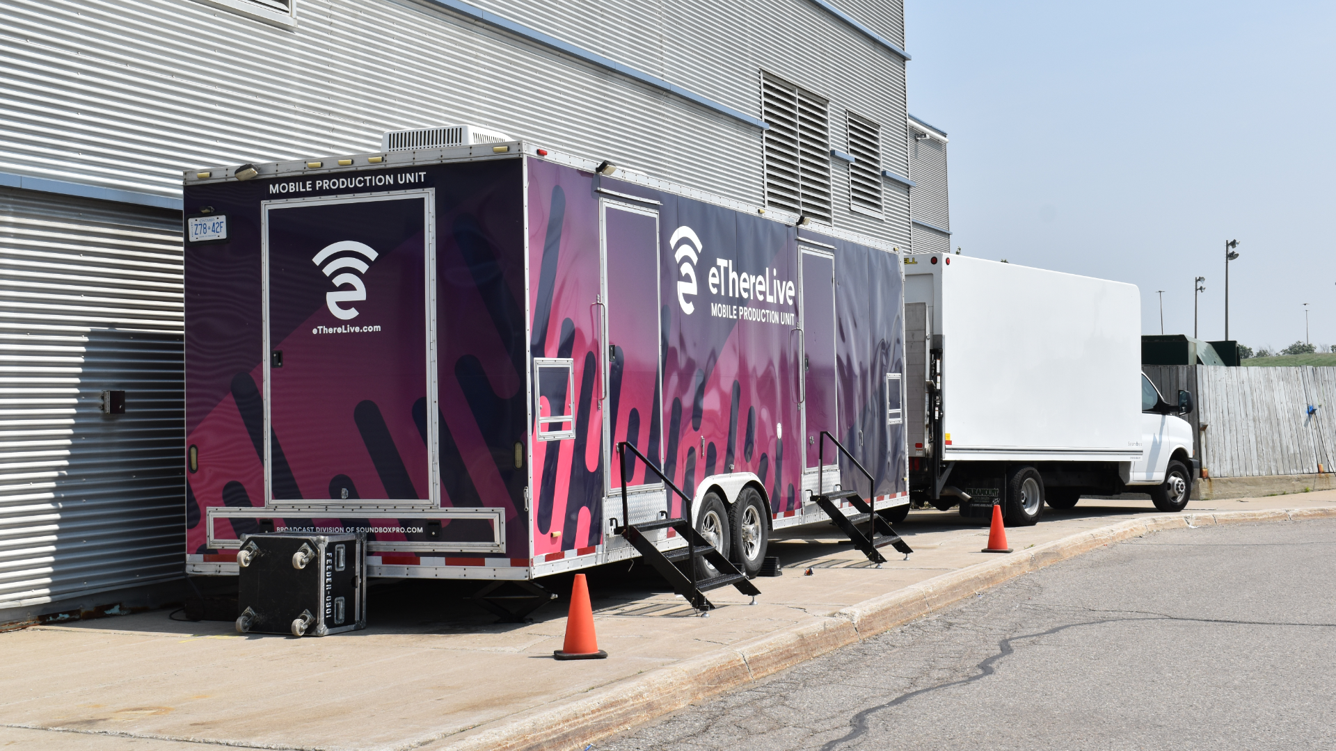 A broadcast trailer is seen outside an arena